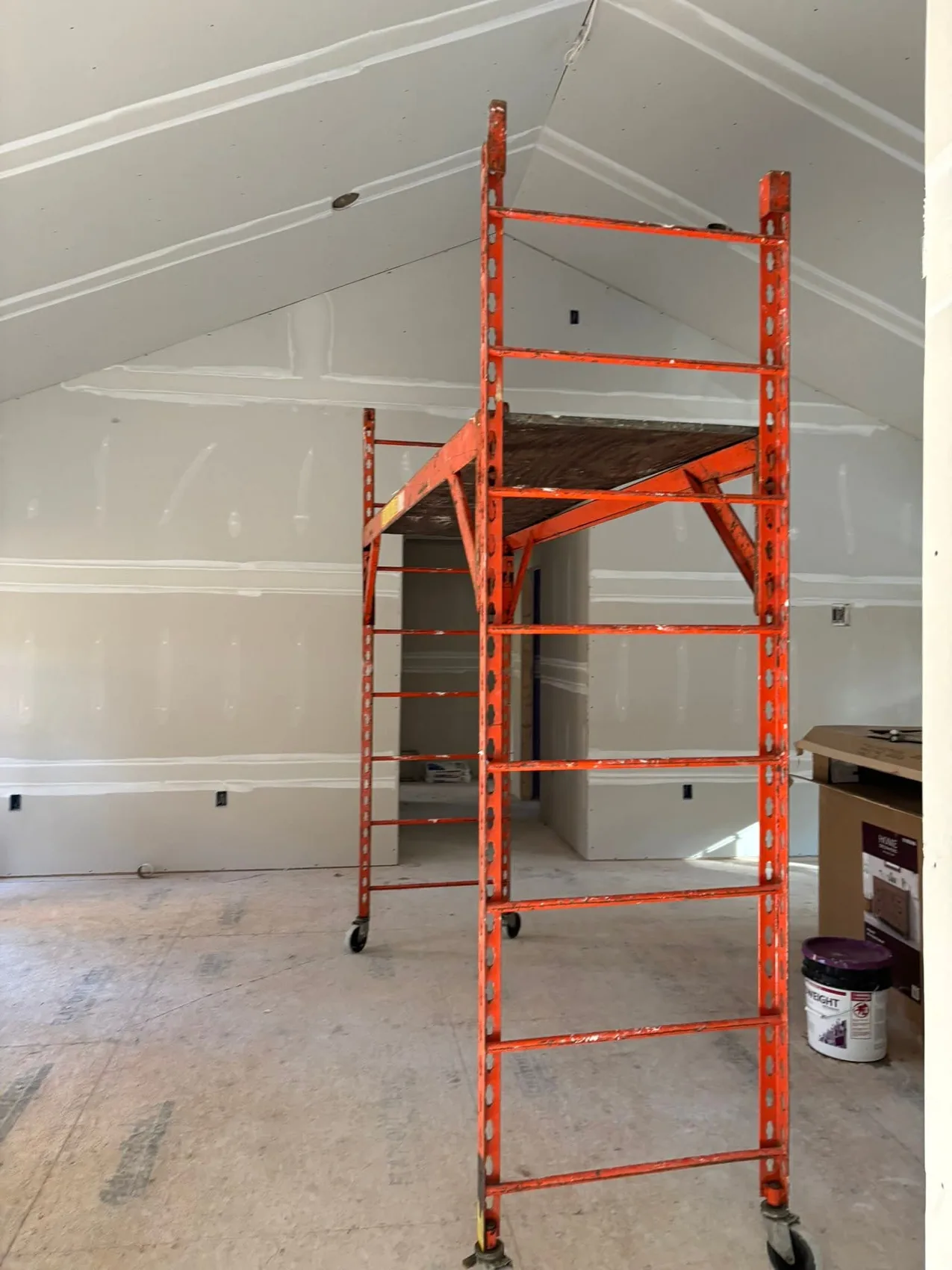 Vaulted drywall room with scaffold